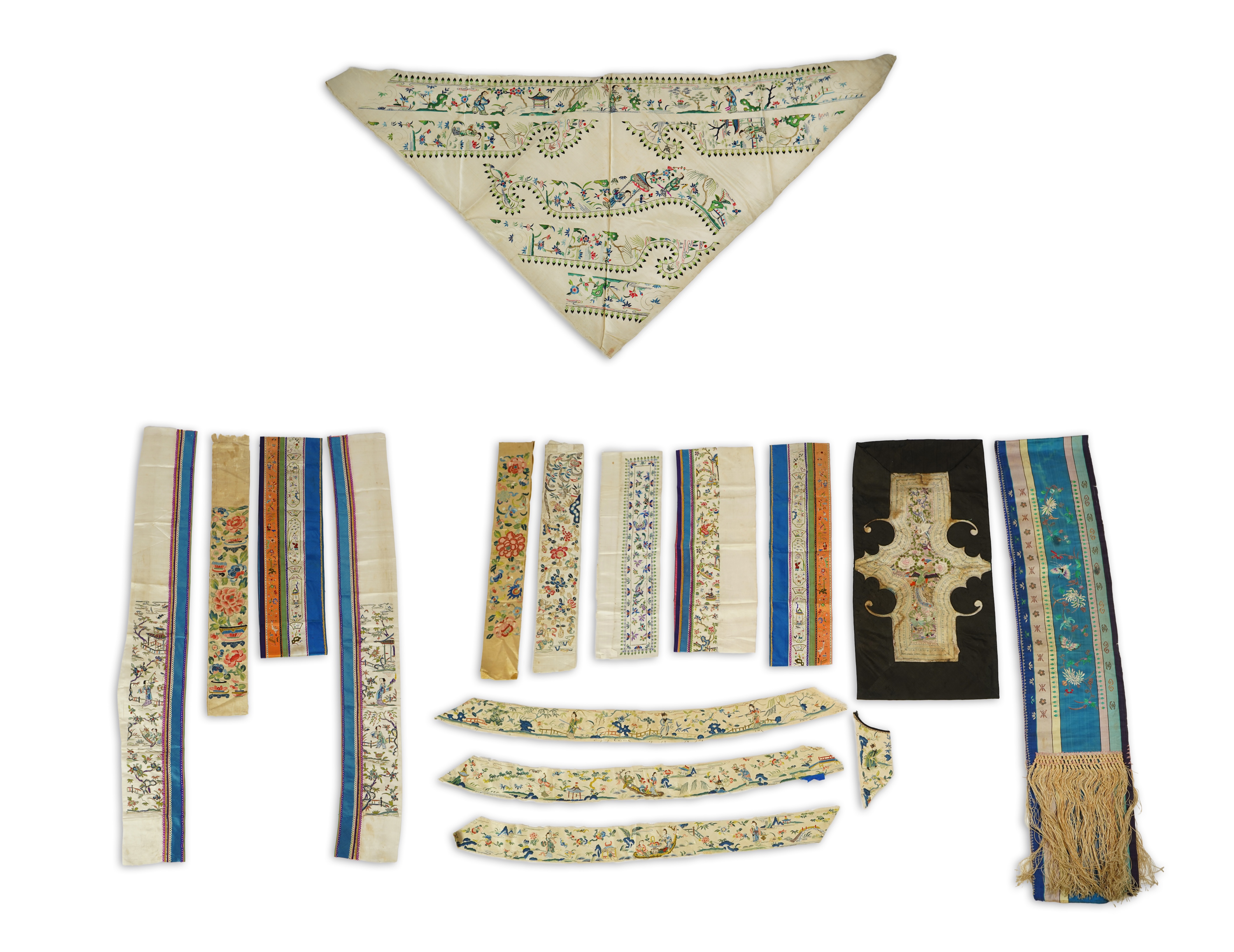 A Chinese embroidered silk panel of uncut robe borders, eleven similar sleeve panels and two other items, late Qing dynasty
